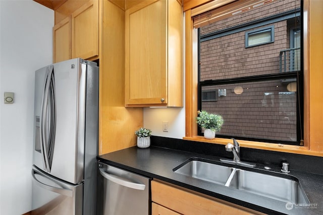 kitchen featuring appliances with stainless steel finishes, sink, and light brown cabinets