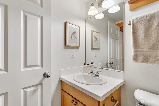 bathroom with vanity and toilet