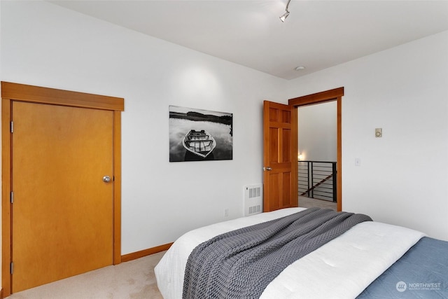 carpeted bedroom with track lighting