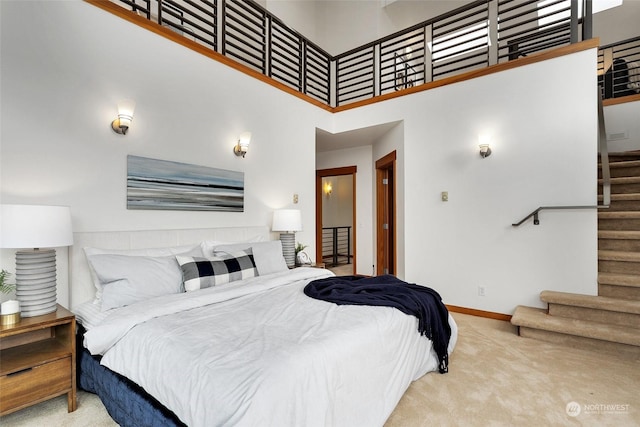 bedroom featuring a towering ceiling and carpet floors