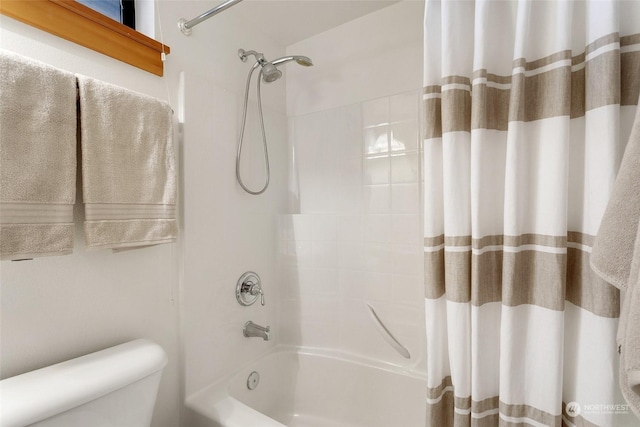 bathroom featuring shower / tub combo with curtain and toilet