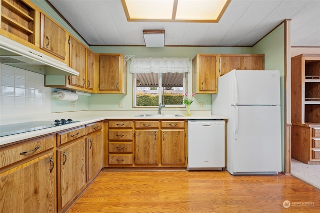 kitchen featuring tasteful backsplash, sink, white appliances, and light hardwood / wood-style floors