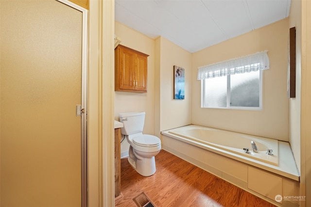 bathroom with shower with separate bathtub, hardwood / wood-style floors, and toilet