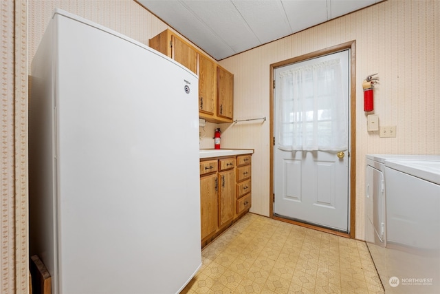 kitchen with washing machine and dryer and white refrigerator