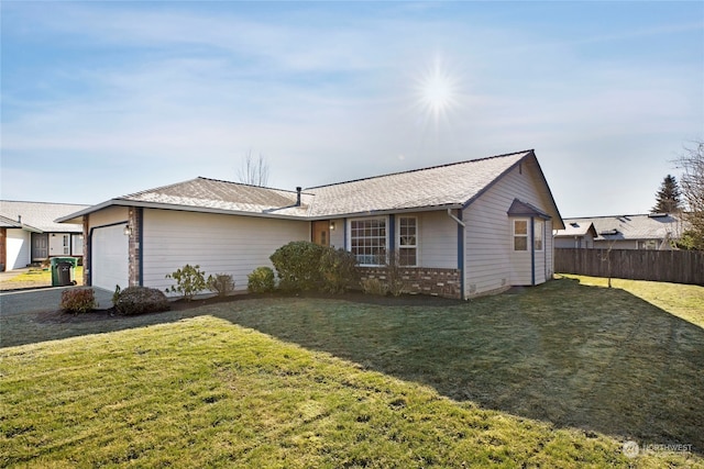 ranch-style house featuring a garage and a front lawn