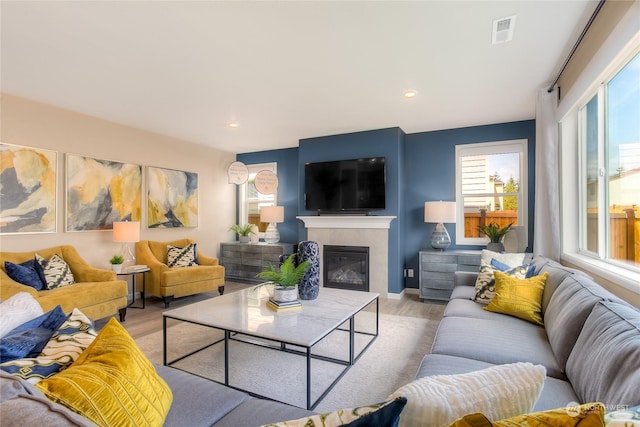 living room with a fireplace and light hardwood / wood-style flooring