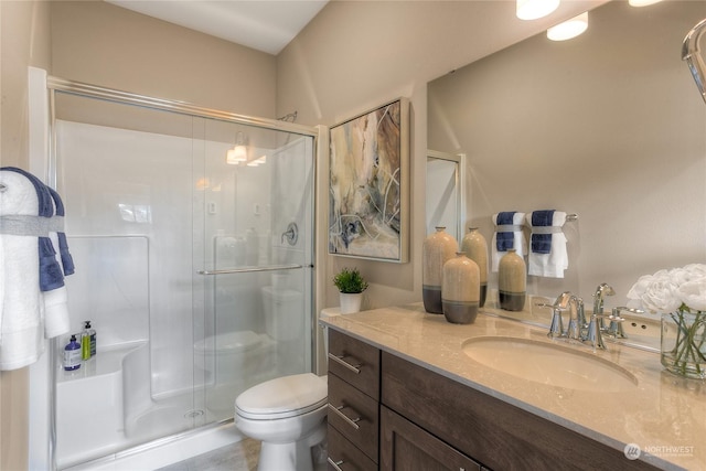 bathroom with vanity, toilet, and an enclosed shower