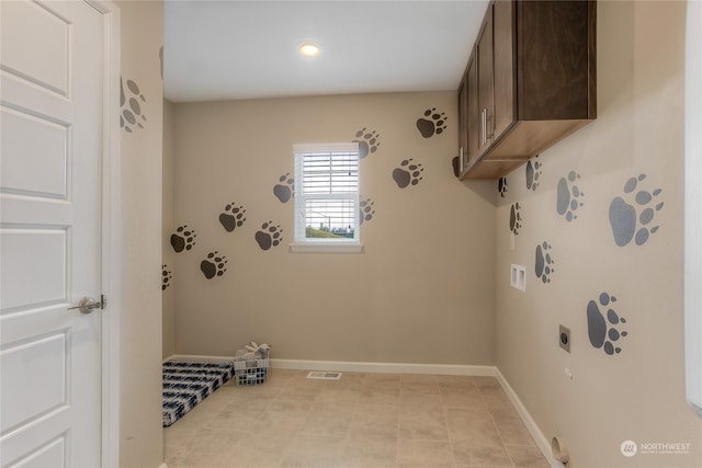 clothes washing area with hookup for a washing machine, cabinets, and hookup for an electric dryer