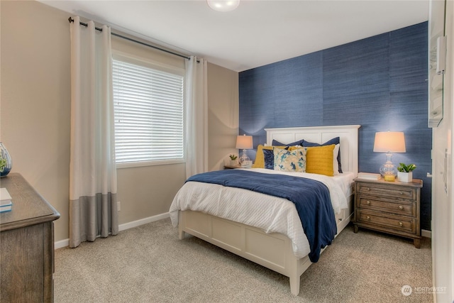 bedroom featuring light colored carpet and multiple windows