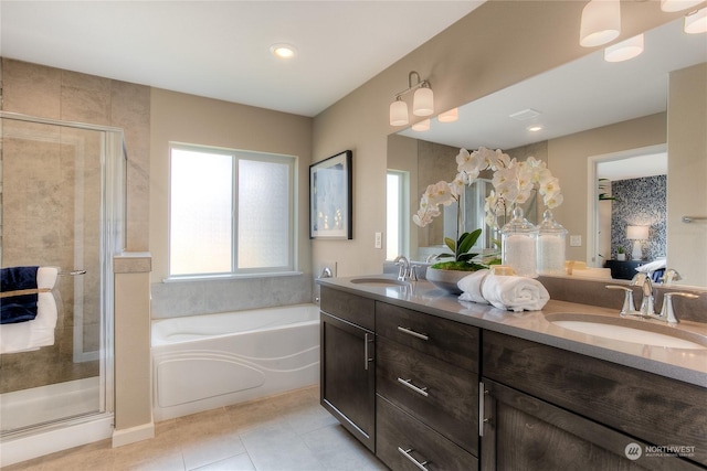 bathroom featuring tile patterned flooring, vanity, and shower with separate bathtub