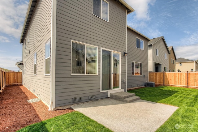 rear view of house with a yard and a patio area