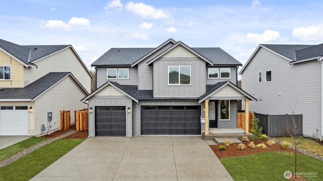 view of front of house featuring an attached garage, a shingled roof, fence, driveway, and board and batten siding