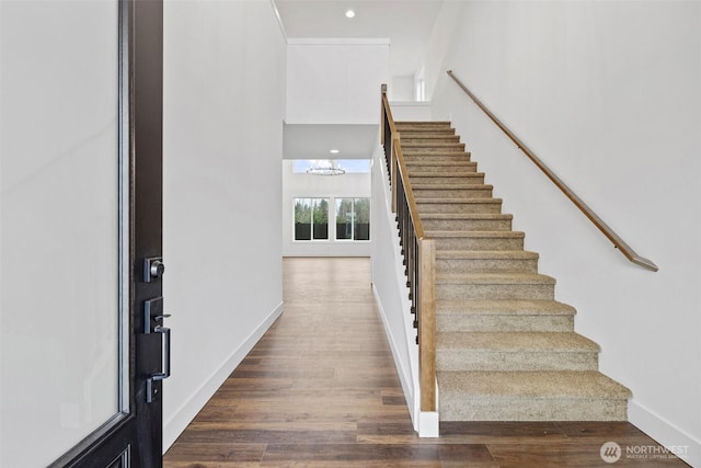 stairway with recessed lighting, baseboards, and wood finished floors