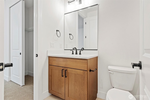 half bathroom with toilet and vanity