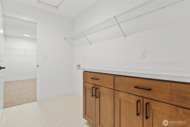 laundry room with laundry area, baseboards, washer hookup, and attic access