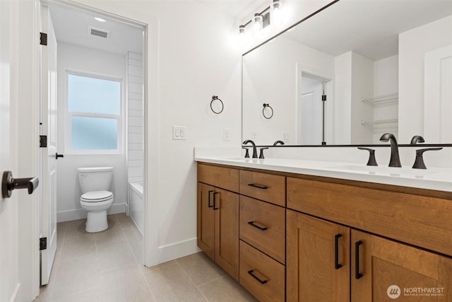 full bath with toilet, double vanity, a sink, and visible vents