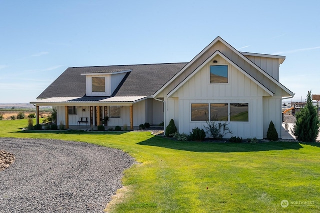 modern inspired farmhouse with a porch and a front yard