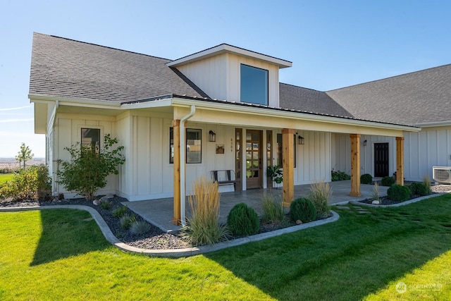 rear view of property with a patio and a lawn