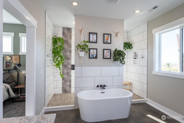 bathroom featuring independent shower and bath and tile walls