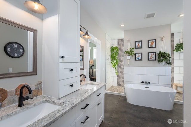 bathroom featuring independent shower and bath, vanity, concrete floors, and tile walls