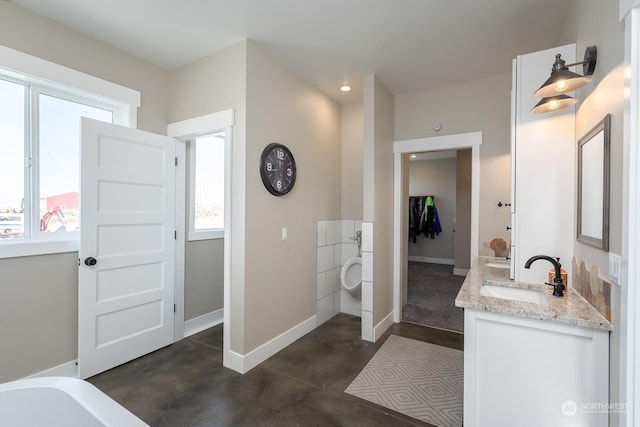 bathroom with vanity and concrete flooring