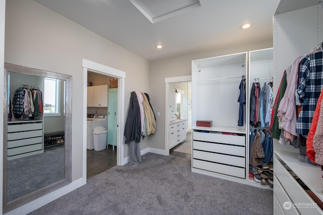 spacious closet featuring dark carpet and washing machine and dryer