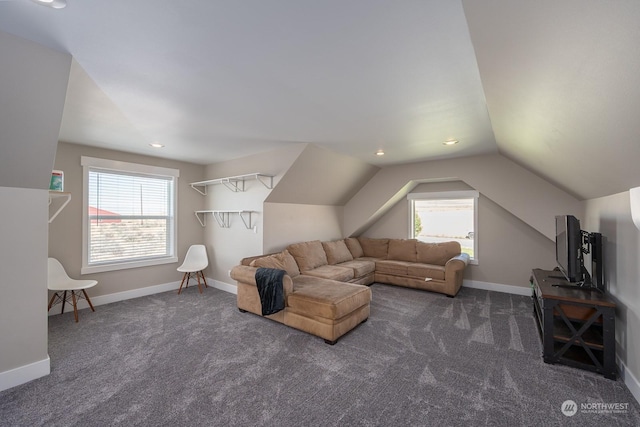 living room featuring dark colored carpet and vaulted ceiling