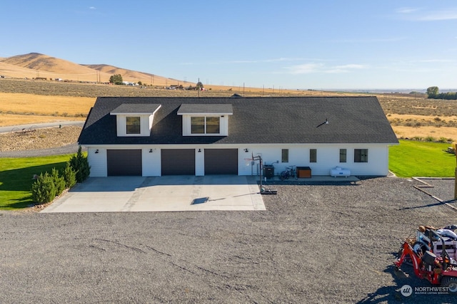 view of front of property with a mountain view and a garage