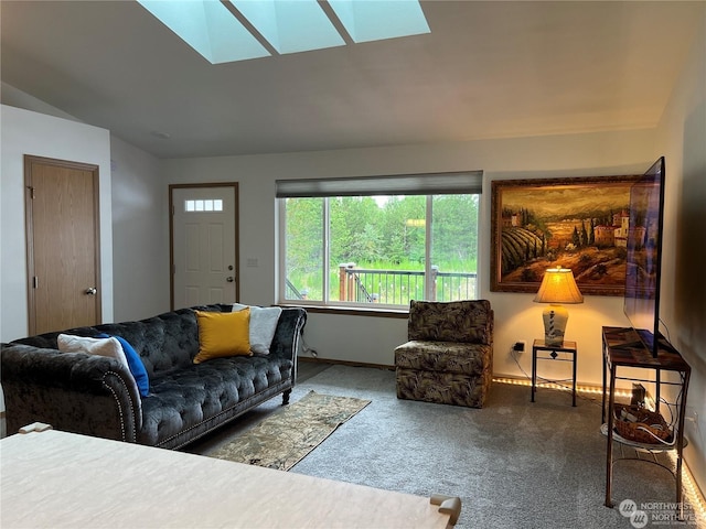 carpeted living room with vaulted ceiling with skylight