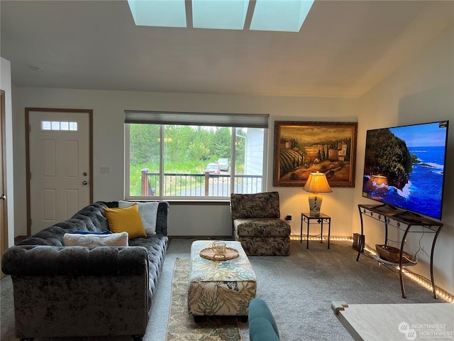 living room featuring lofted ceiling with skylight and carpet floors