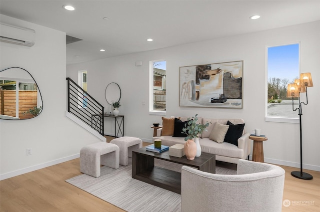 living room featuring light hardwood / wood-style floors and a wall mounted air conditioner