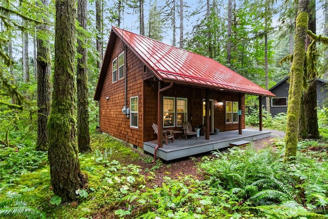 back of house with a standing seam roof and metal roof