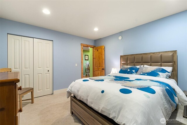 bedroom with recessed lighting, a closet, baseboards, and light colored carpet