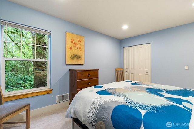 carpeted bedroom with recessed lighting, visible vents, baseboards, and a closet