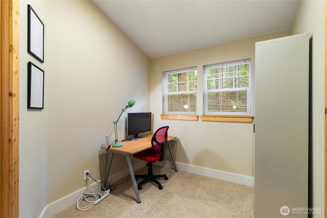 home office featuring lofted ceiling, speckled floor, and baseboards