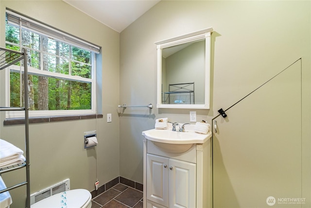 bathroom with vanity, visible vents, lofted ceiling, tile patterned floors, and toilet