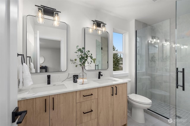 bathroom featuring walk in shower, vanity, tile patterned floors, and toilet