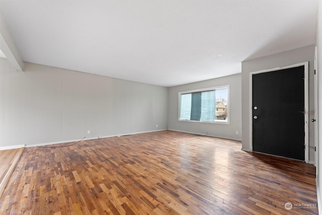 unfurnished living room with wood-type flooring