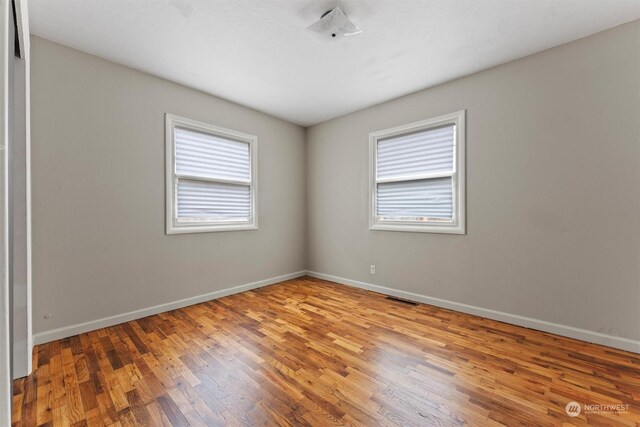 unfurnished room with light hardwood / wood-style flooring