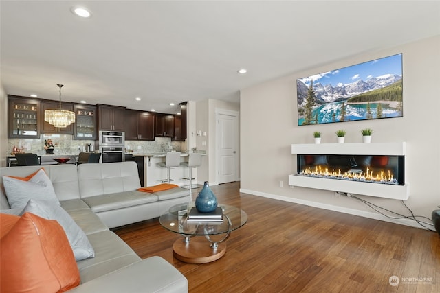 living room featuring dark hardwood / wood-style floors and a notable chandelier