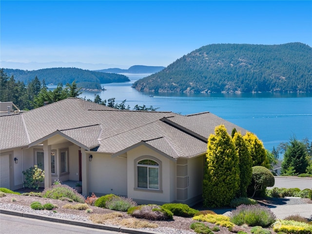 exterior space featuring a water and mountain view