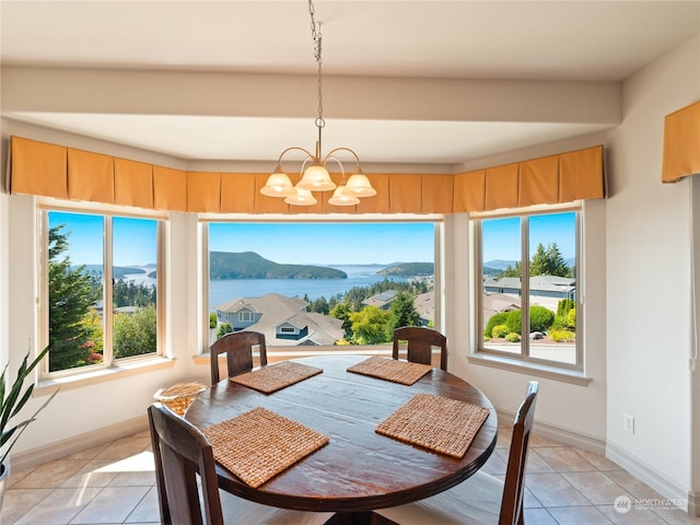 tiled dining area with a water and mountain view and a notable chandelier