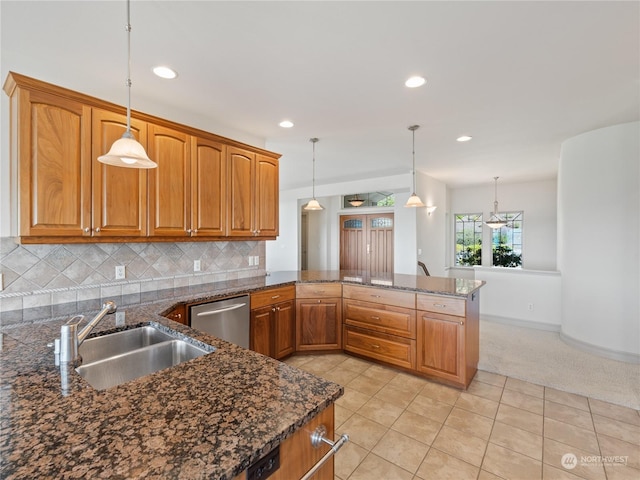 kitchen with dishwasher, decorative light fixtures, and sink