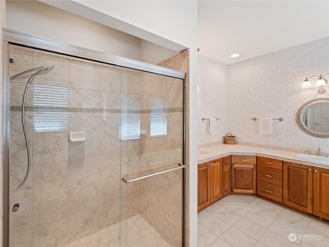 bathroom with vanity, tile patterned floors, and walk in shower