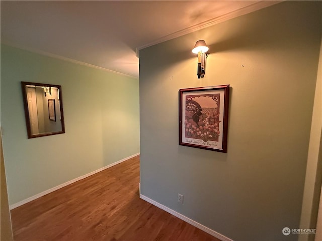 corridor featuring wood-type flooring and crown molding