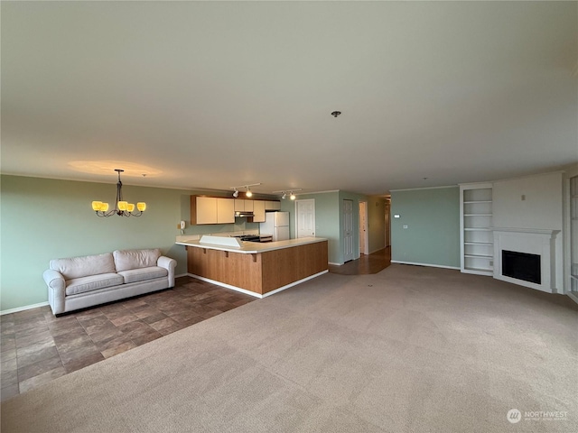 unfurnished living room featuring dark carpet and a notable chandelier