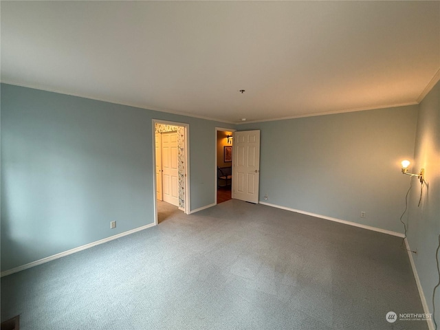 unfurnished bedroom with carpet flooring, a spacious closet, a closet, and crown molding