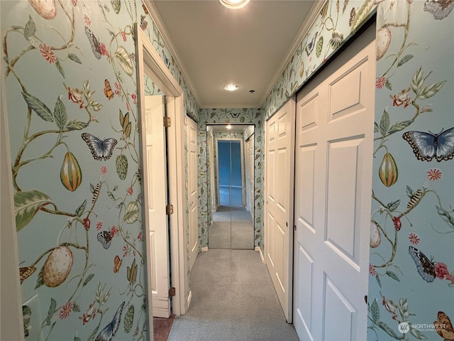 hallway featuring light colored carpet and crown molding