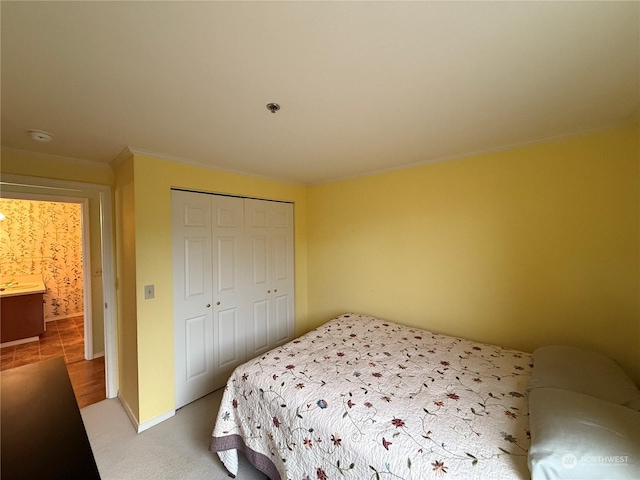 bedroom with light carpet and a closet