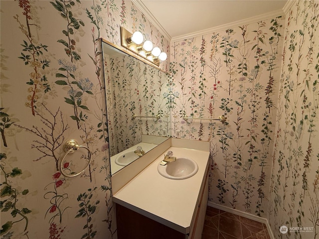 bathroom featuring tile patterned floors, crown molding, and vanity